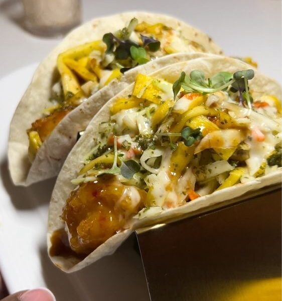 Two glazed fish tacos with mango slaw and microgreens at Sugar'd